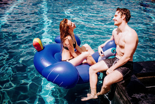 Sexy couple playing in the swimming pool